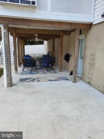 a view of room with two mirror and furniture