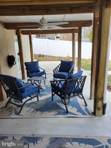 a view of a dining room with furniture and a window