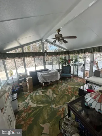 a living room with lots of furniture and white walls