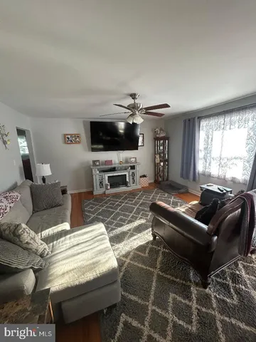 a living room with furniture a large window and a flat screen tv