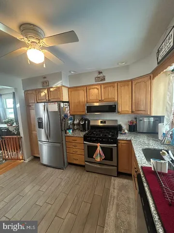 a kitchen with a stove a sink and a refrigerator