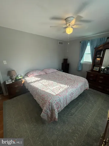 a bedroom with a bed and dresser
