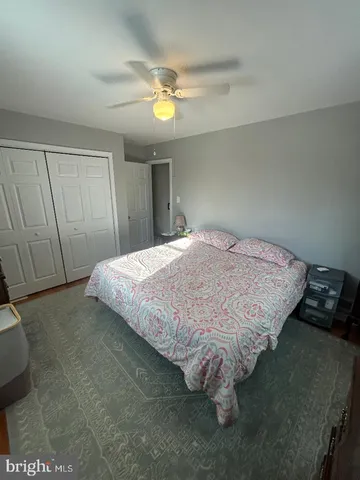 a bed sitting in a bedroom and chandelier