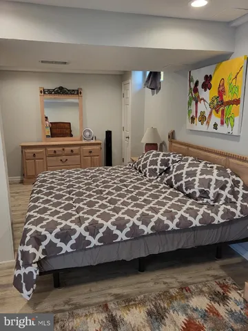 a bedroom with a bed and dresser