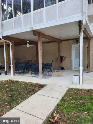 a view of a house with backyard porch and furniture
