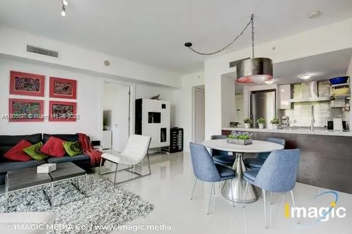 a living room with furniture and large windows