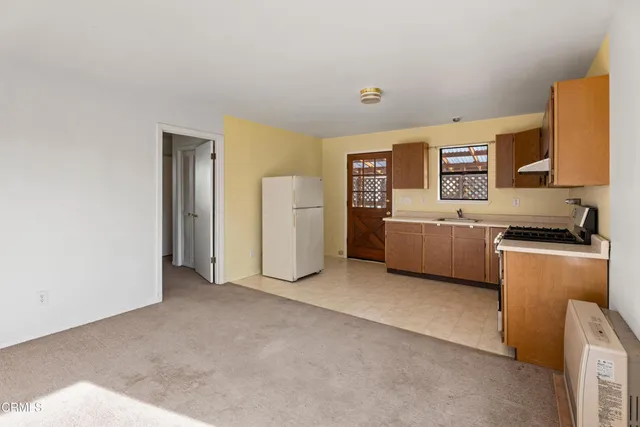 a kitchen with a sink a stove and a refrigerator