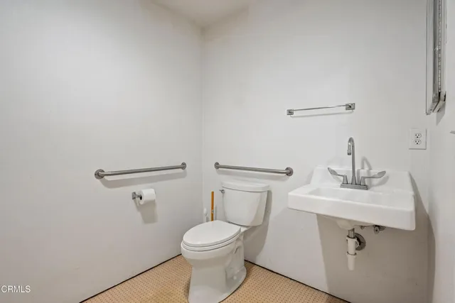 a bathroom with a sink a toilet and mirror