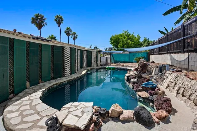 a view of a backyard with plants and patio
