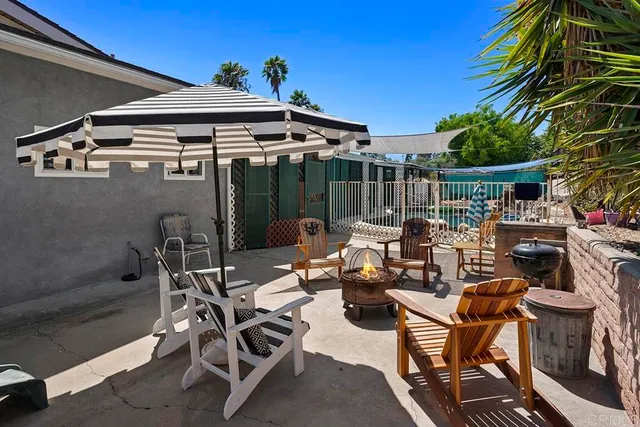 a view of a patio with table and chairs potted plants with wooden floor