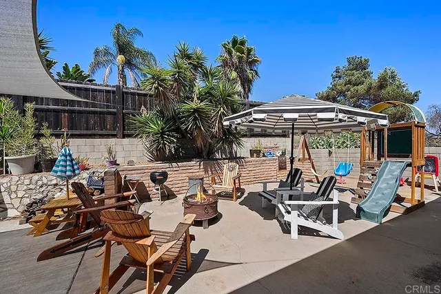 a view of a patio with table and chairs potted plants