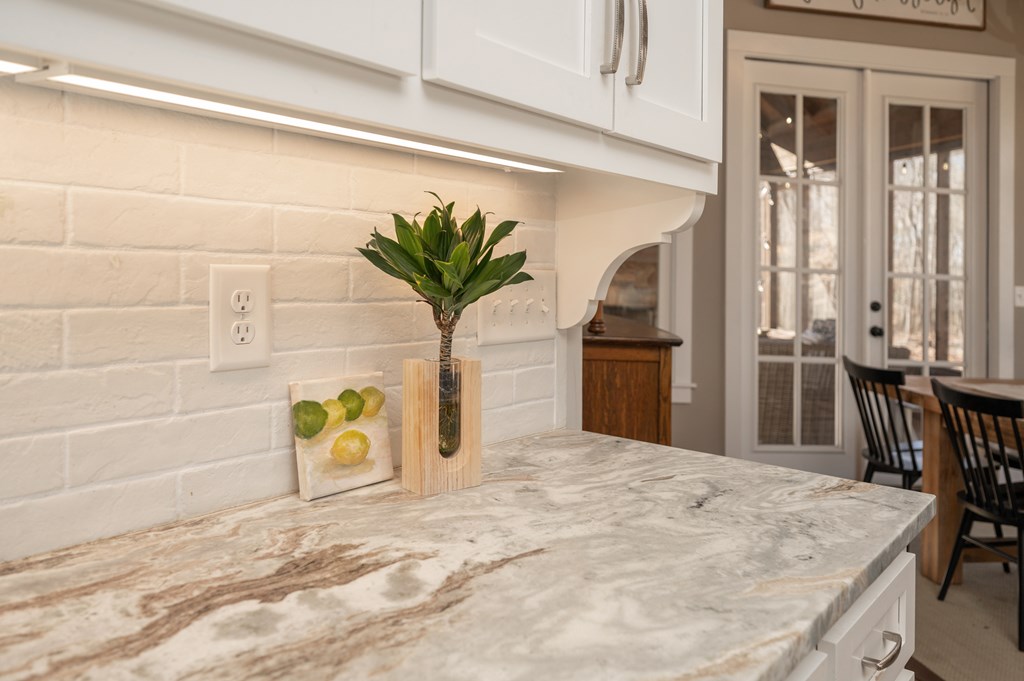 1652 Pierce Road Waverly Hall, GA 31831 - Photo 18 of 51 a swimming pool with a potted plant on a table and chair