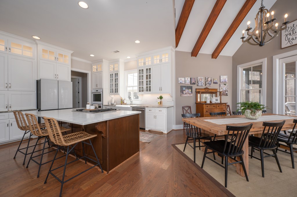 1652 Pierce Road Waverly Hall, GA 31831 - Photo 19 of 51 a dining hall with stainless steel appliances a table chairs and a kitchen view