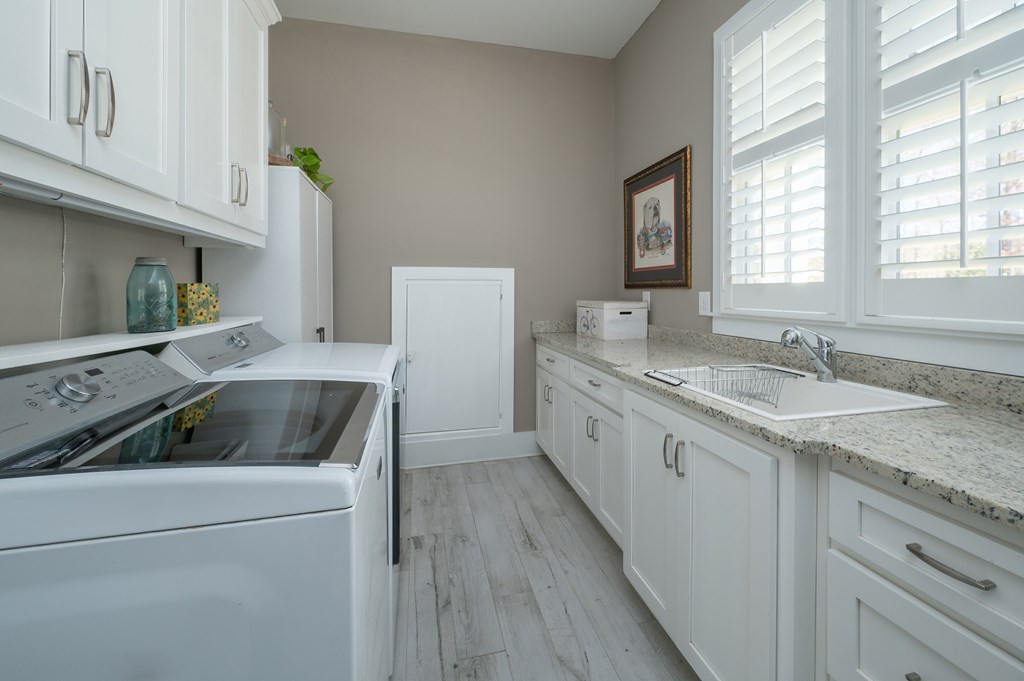 1652 Pierce Road Waverly Hall, GA 31831 - Photo 27 of 51 a kitchen with a sink stove and cabinets