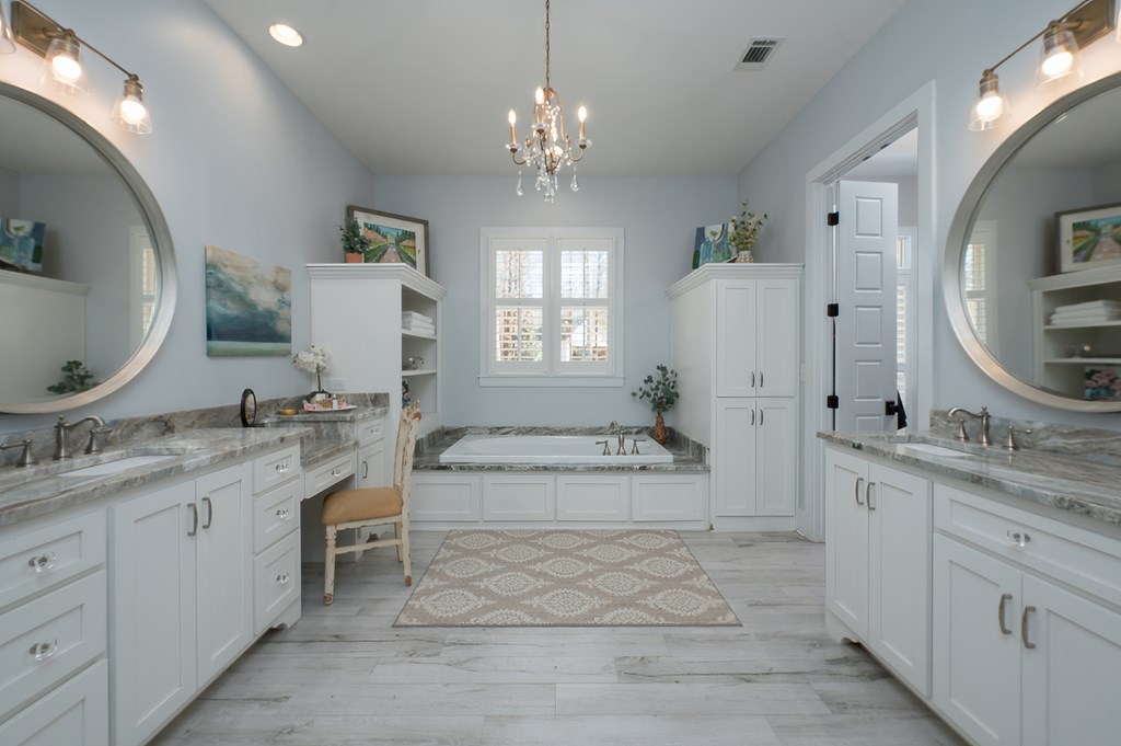 1652 Pierce Road Waverly Hall, GA 31831 - Photo 33 of 51 a spacious bathroom with a granite countertop sink a mirror and a vanity
