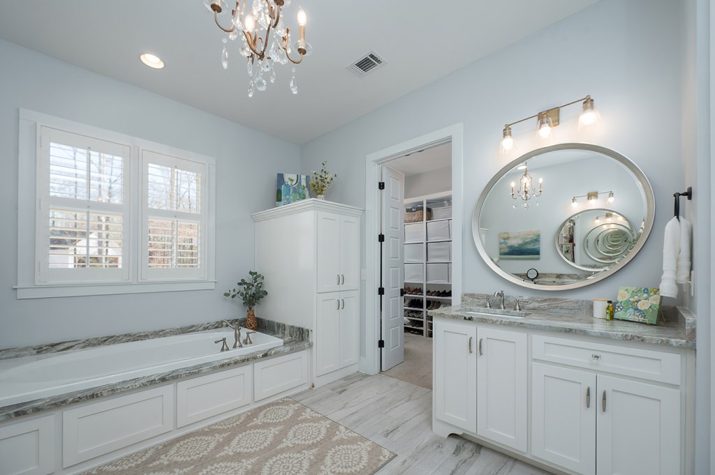 1652 Pierce Road Waverly Hall, GA 31831 - Photo 35 of 51 a spacious bathroom with a tub sink and mirror