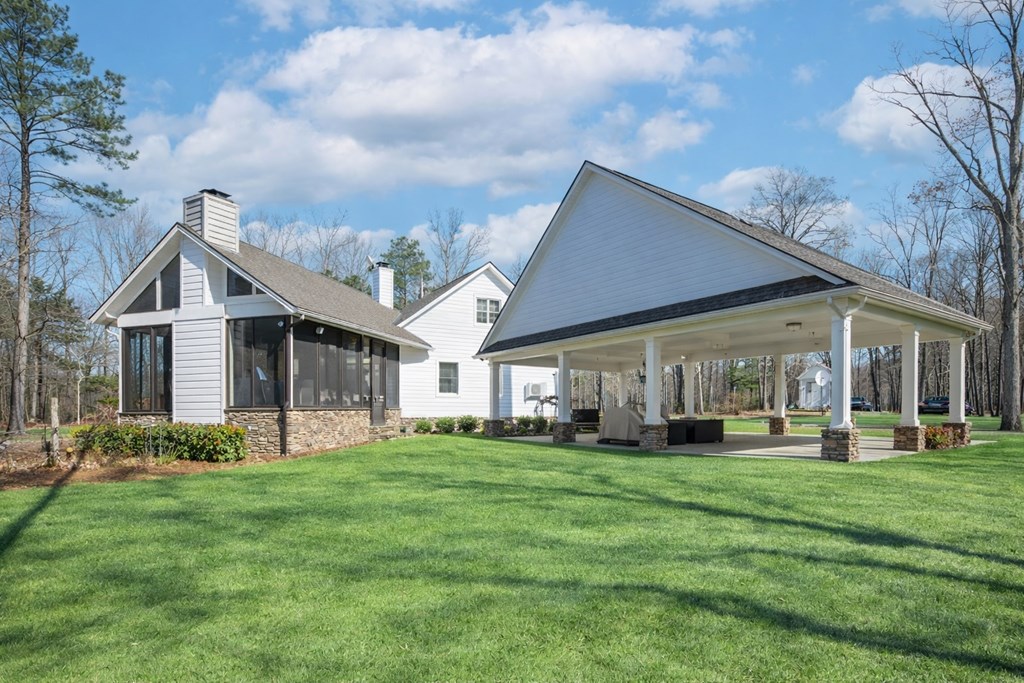 1652 Pierce Road Waverly Hall, GA 31831 - Photo 46 of 51 a front view of a house with a yard and trees