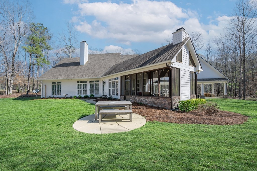 1652 Pierce Road Waverly Hall, GA 31831 - Photo 47 of 51 a front view of a house with a yard table and chairs