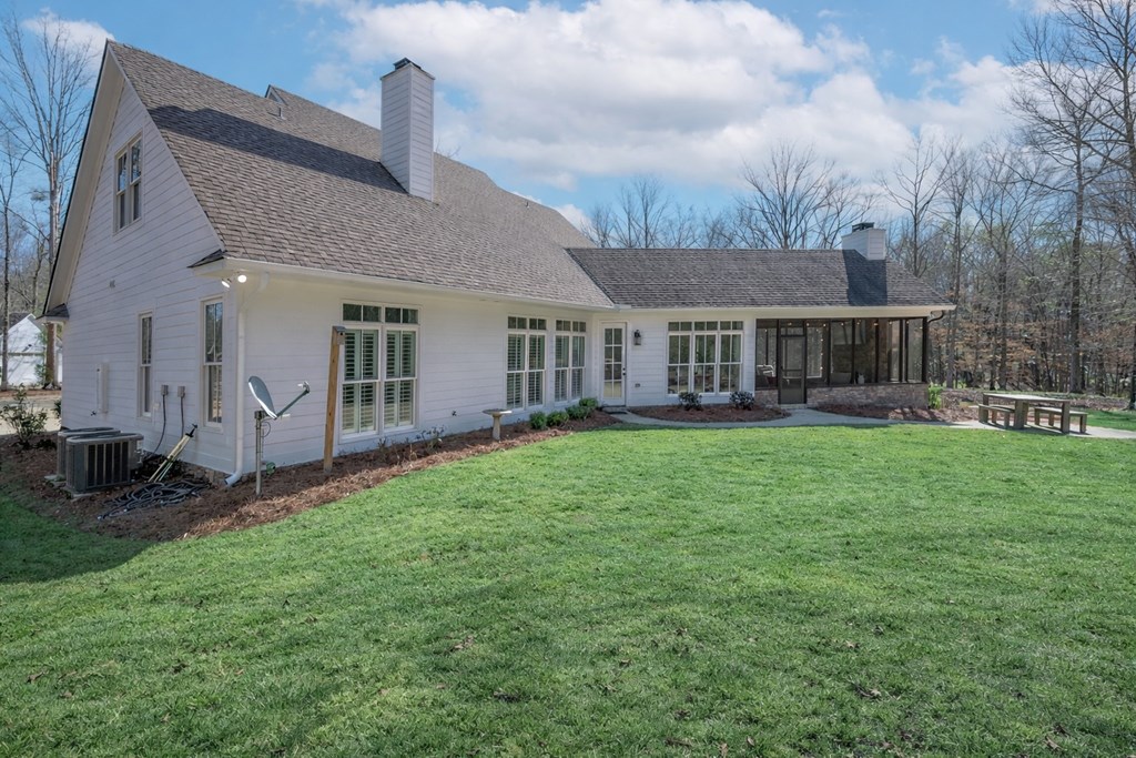 1652 Pierce Road Waverly Hall, GA 31831 - Photo 49 of 51 a front view of a house with a garden and plants