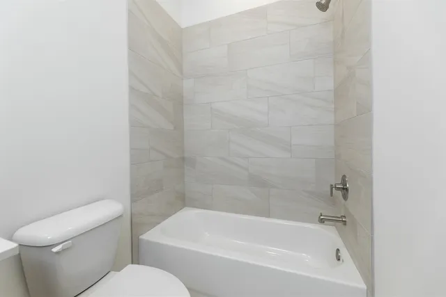 a white bath tub sitting next to a white toilet