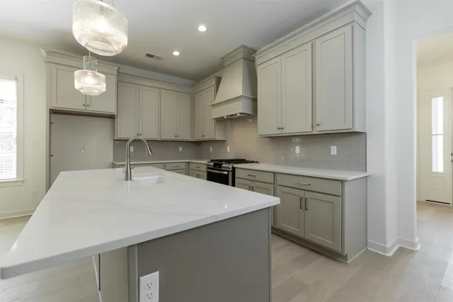 a kitchen with a sink cabinets and window
