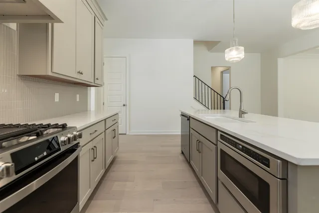 a kitchen with granite countertop a stove and a sink
