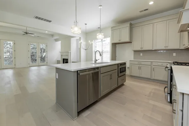 a kitchen with a sink cabinets and window