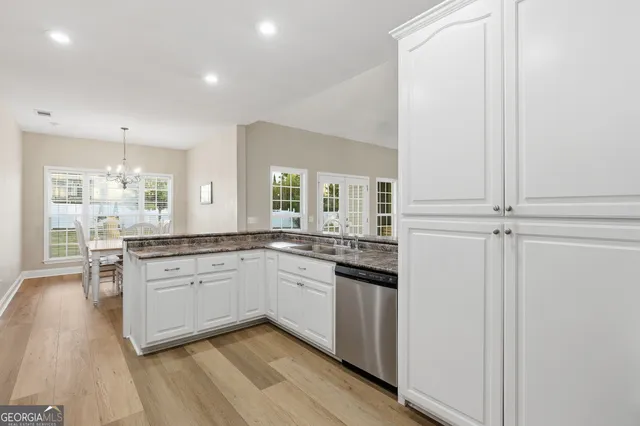 a bedroom with a bed couch and a view of kitchen