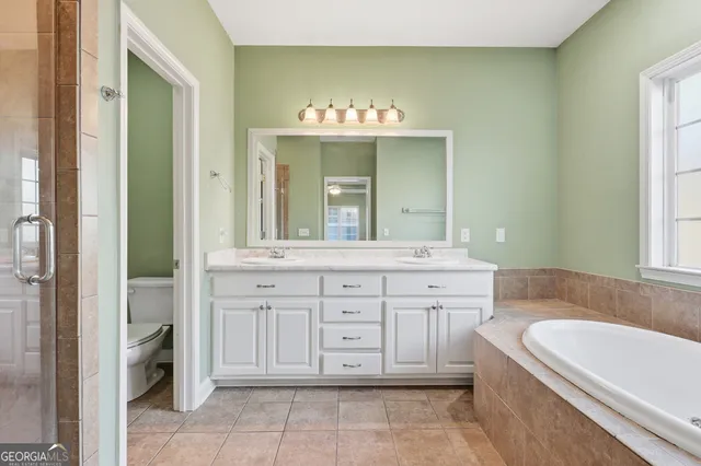 a bathroom with a tub a sink and a window