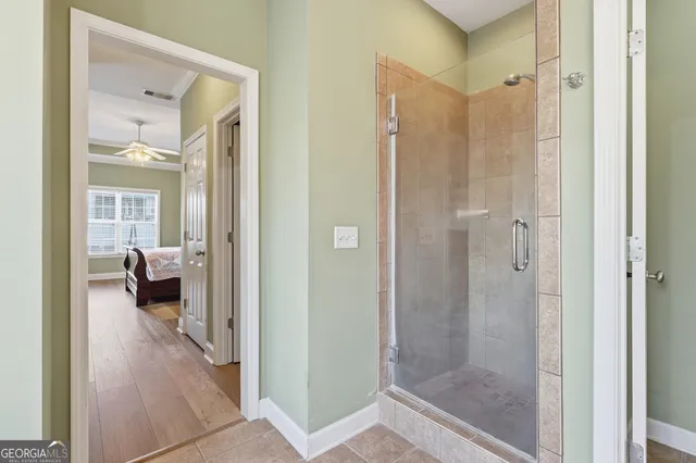 an empty room with windows and ceiling fan