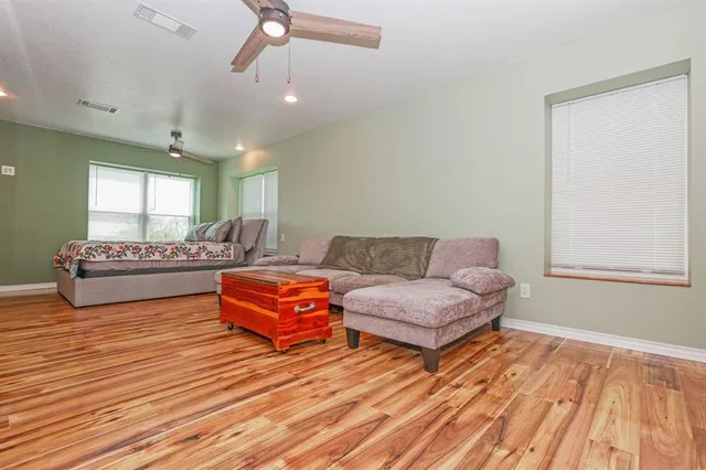 a view of a hallway with wooden floor and staircase