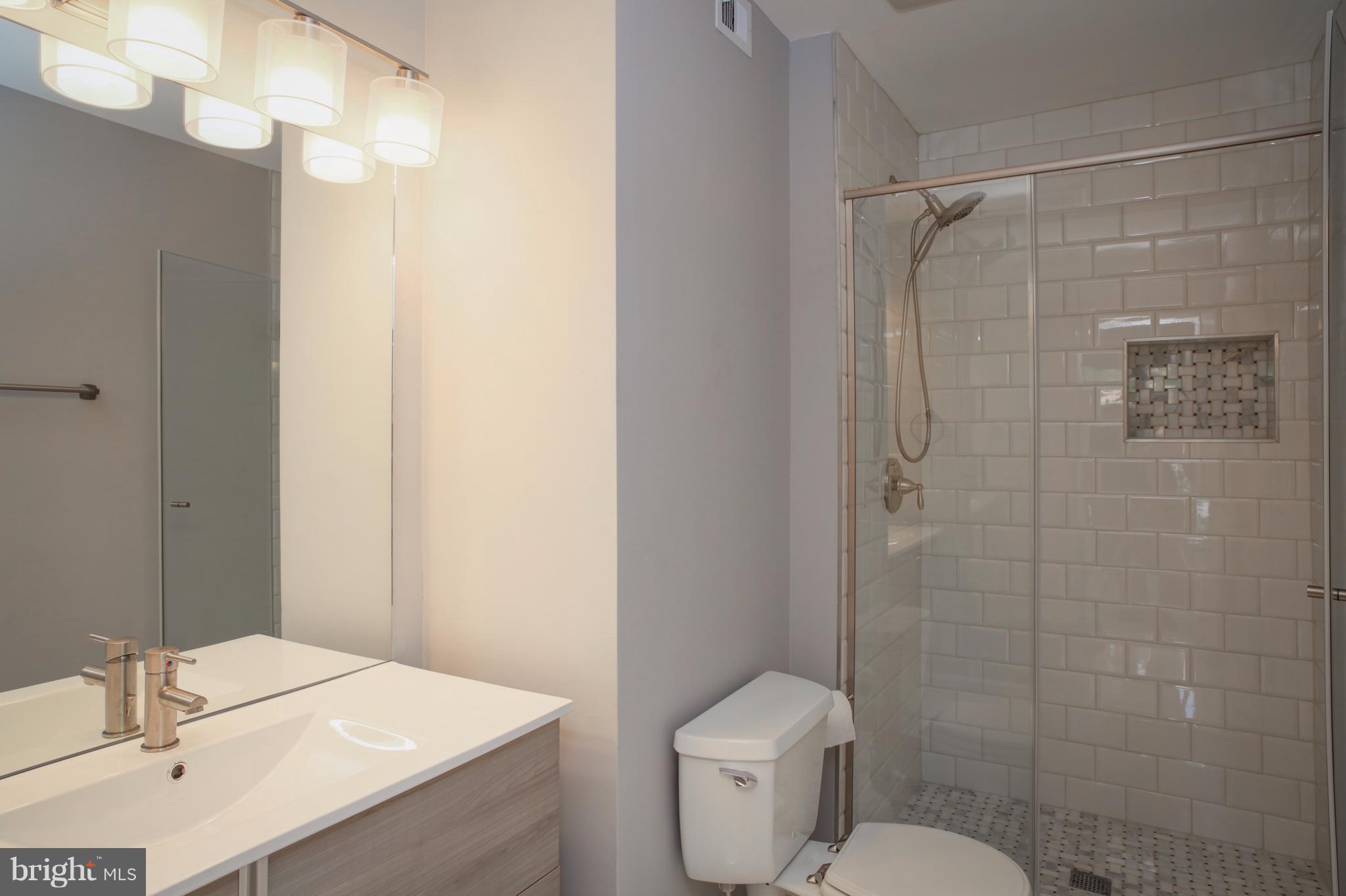 11616 Ivystone Court, Unit 301 Reston, VA 20191 - Photo 18 of 29 a bathroom with a sink toilet vanity and shower