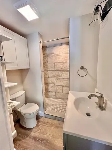a bathroom with a tub sink toilet and a mirror