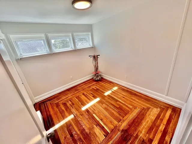 a view of a room with wooden floor and chair