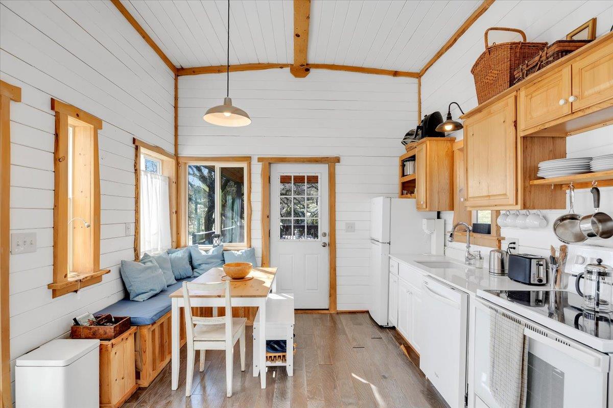 2460 Sulkey Court Copperopolis, CA 95228 - Photo 12 of 91 a dining room with stainless steel appliances kitchen island granite countertop a table chairs and a refrigerator
