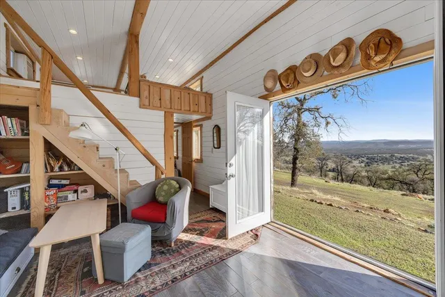 a backyard of a house with barbeque oven and outdoor seating