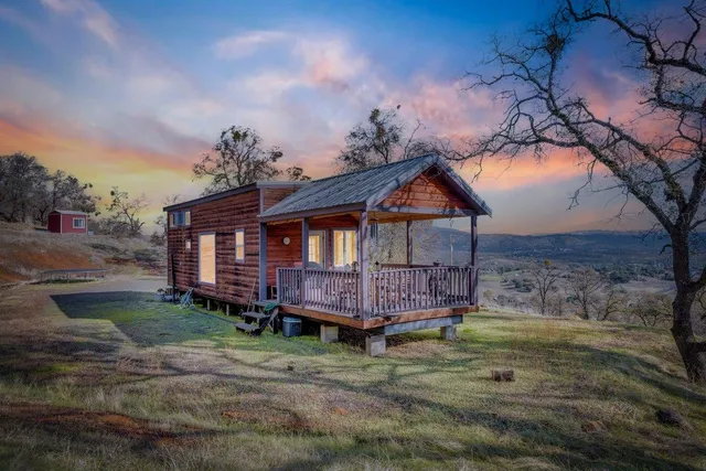 a view of a backyard with table and chairs and a fire pit