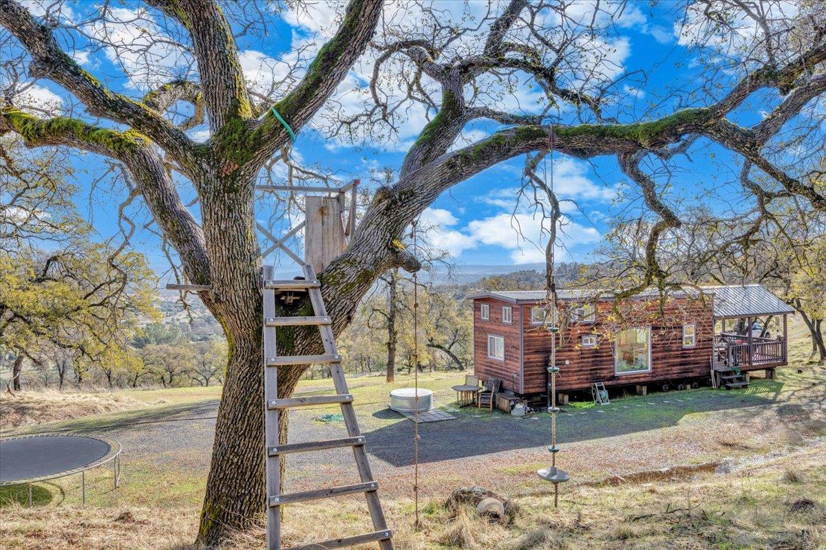 2460 Sulkey Court Copperopolis, CA 95228 - Photo 34 of 91 a backyard of a house with barbeque oven table and chairs