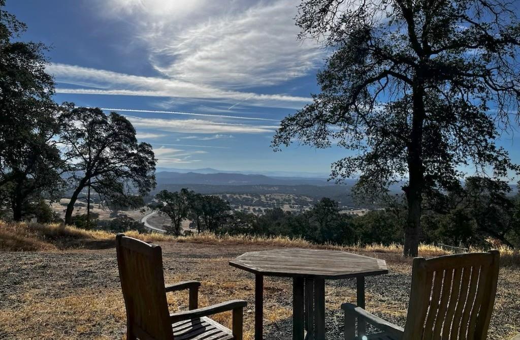 2460 Sulkey Court Copperopolis, CA 95228 - Photo 42 of 91 a view of a backyard with table and chairs and a fire pit