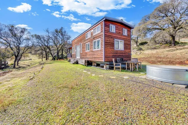 a backyard of a house with lots of green space and trees