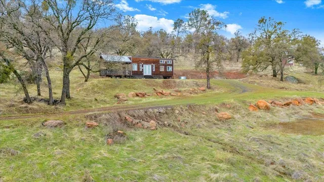 a dining room with stainless steel appliances kitchen island granite countertop a table chairs and a refrigerator