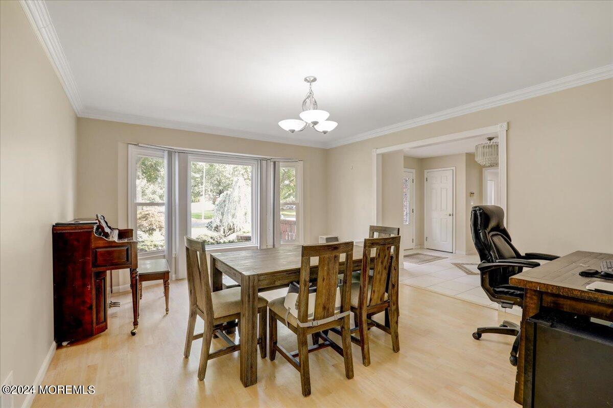 61 Apache Drive Manalapan, NJ 07726 - Photo 15 of 37 a view of a dining room with furniture and chandelier