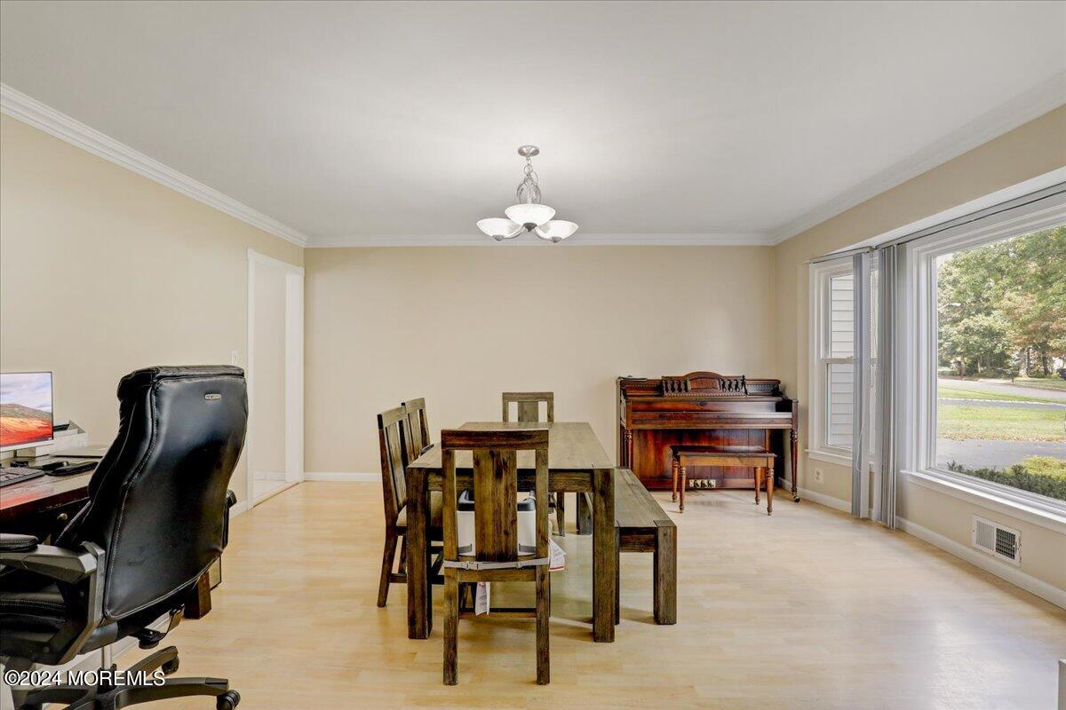 61 Apache Drive Manalapan, NJ 07726 - Photo 16 of 37 a dining room with furniture and a floor to ceiling window