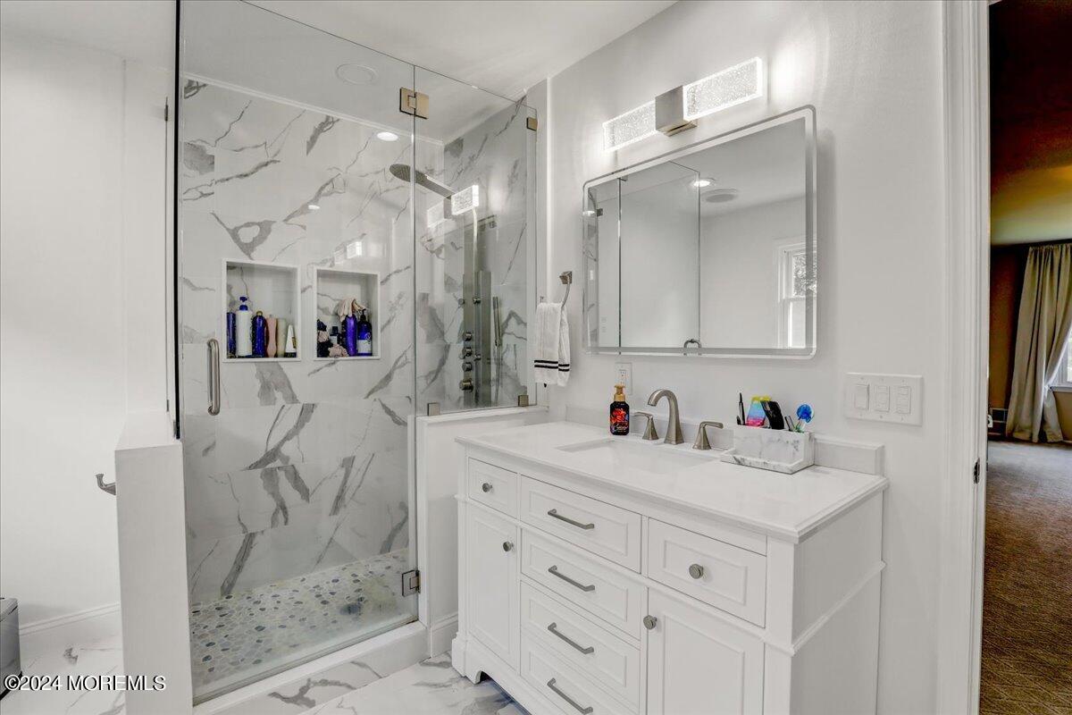 61 Apache Drive Manalapan, NJ 07726 - Photo 24 of 37 a bathroom with a sink vanity and a mirror