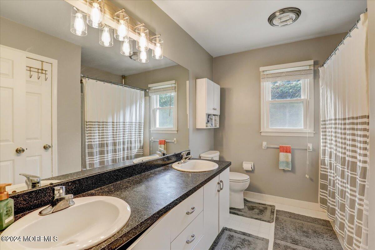 61 Apache Drive Manalapan, NJ 07726 - Photo 26 of 37 a bathroom with a sink double vanity and a mirror