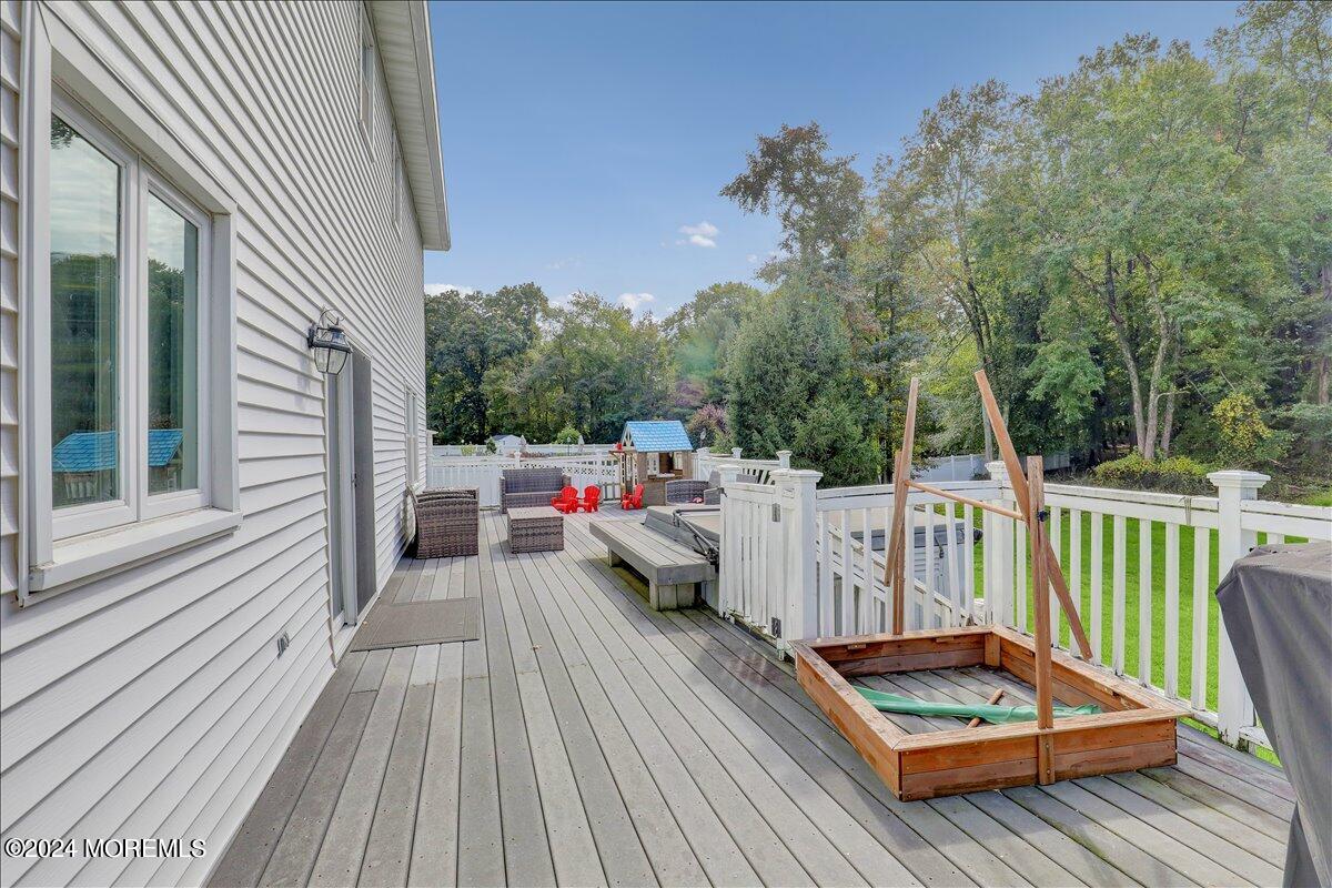 61 Apache Drive Manalapan, NJ 07726 - Photo 31 of 37 a view of roof deck with couches and wooden floor