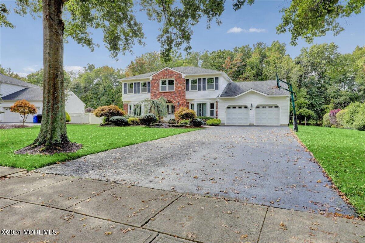 61 Apache Drive Manalapan, NJ 07726 - Photo 4 of 37 a front view of a house with a yard and garage