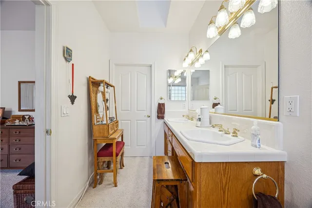 a bathroom with a sink mirror and a shower