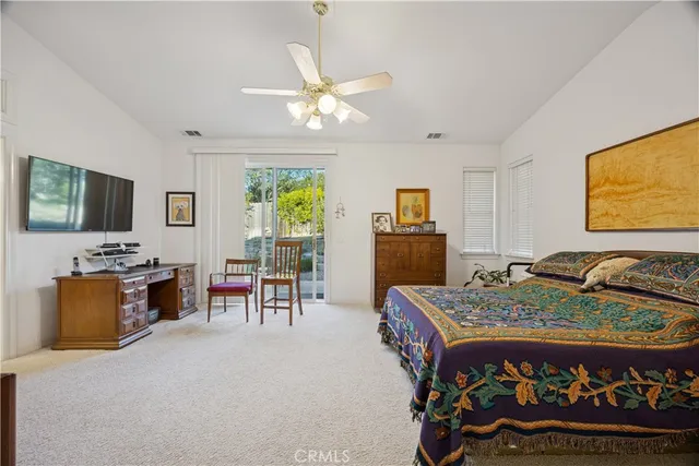 a bed room with furniture and a flat screen tv