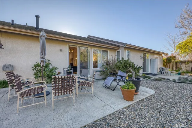 a view of a patio with table and chairs potted plants